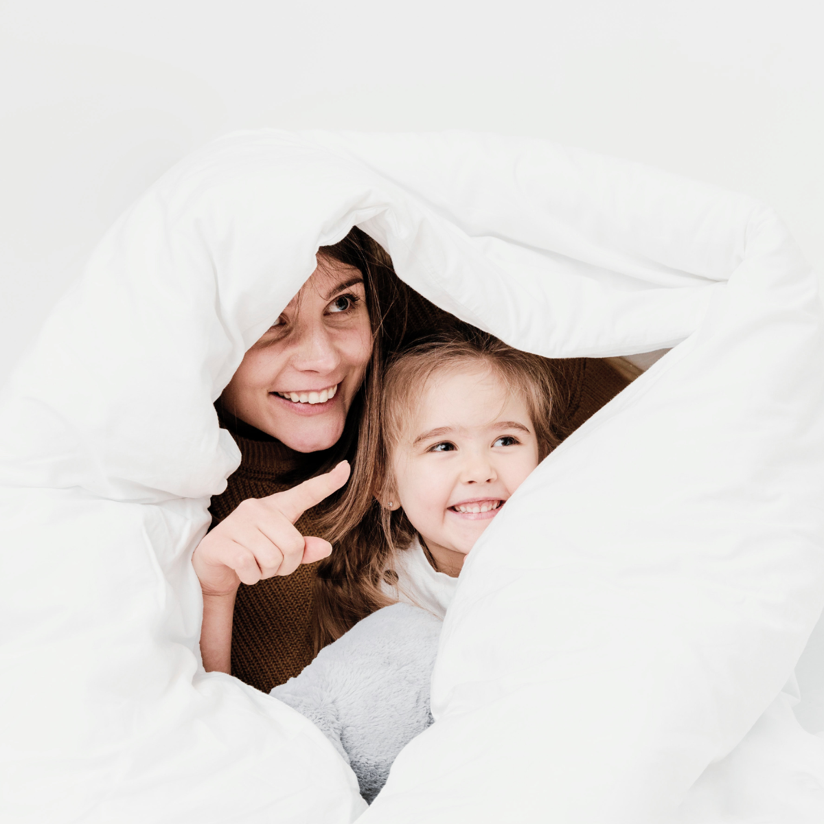 ClimaBalance white duck down and feather duvet embraced on a mother and child with plush softness and balanced insulation.